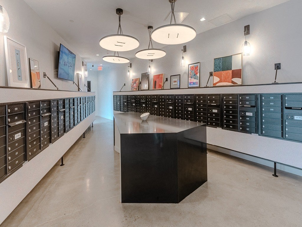 a large room with lockers and a table in the middle